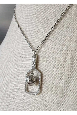 The Volley Plus in silver pickleball necklace on linen