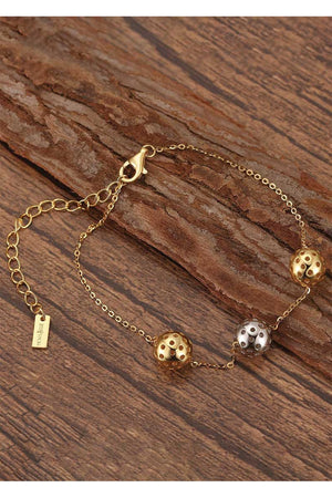 Trio Ball charm bracelet gold and silver on wood backgrounds